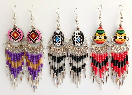Set of five colorful beaded earrings on a white background