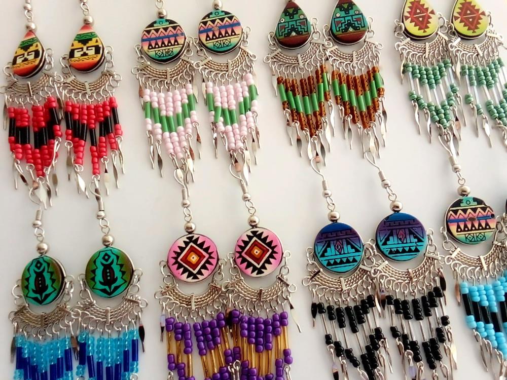 Colorful beaded earrings with intricate designs on a white background