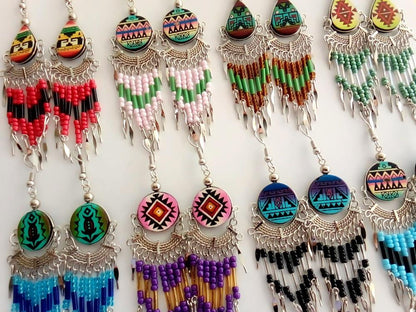 Colorful beaded earrings with intricate designs on a white background